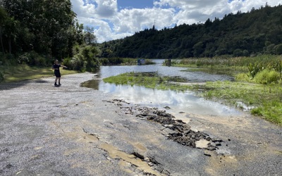 Person standing by a river