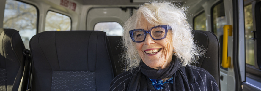 Older woman sitting on a bus