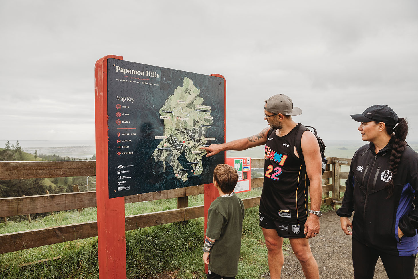 people looking at new signage at papamoa hills